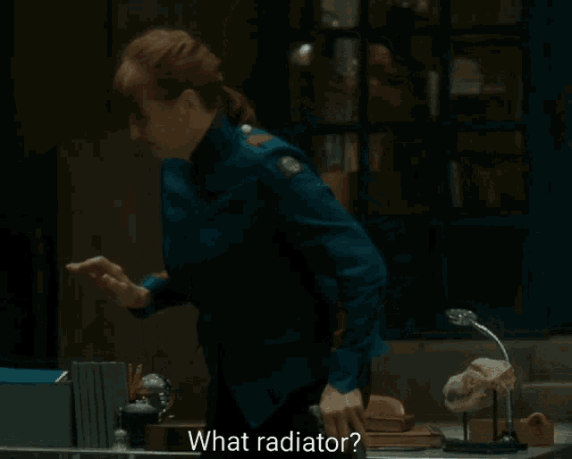 a woman in a blue uniform stands in front of a desk and asks what radiator
