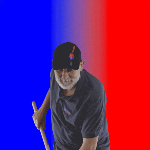 a man holding a broom with a red and blue background