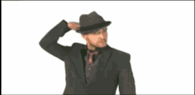 a blurry picture of a man in a suit and tie standing on a green field .