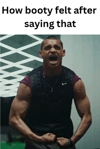 a man is standing in a gym with his arms in the air and screaming .