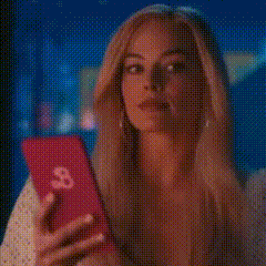 a woman is taking a selfie with her phone .