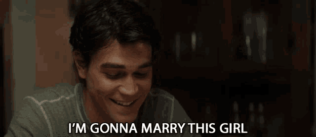 a man says " i 'm gonna marry this girl " while sitting at a table
