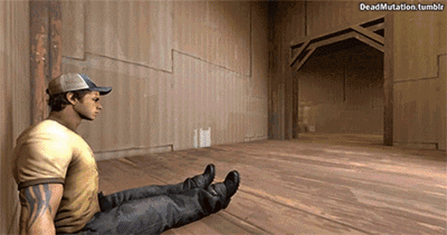 a man in a baseball cap sits on a wooden floor in an empty room with deadmutation.tumblr written below him
