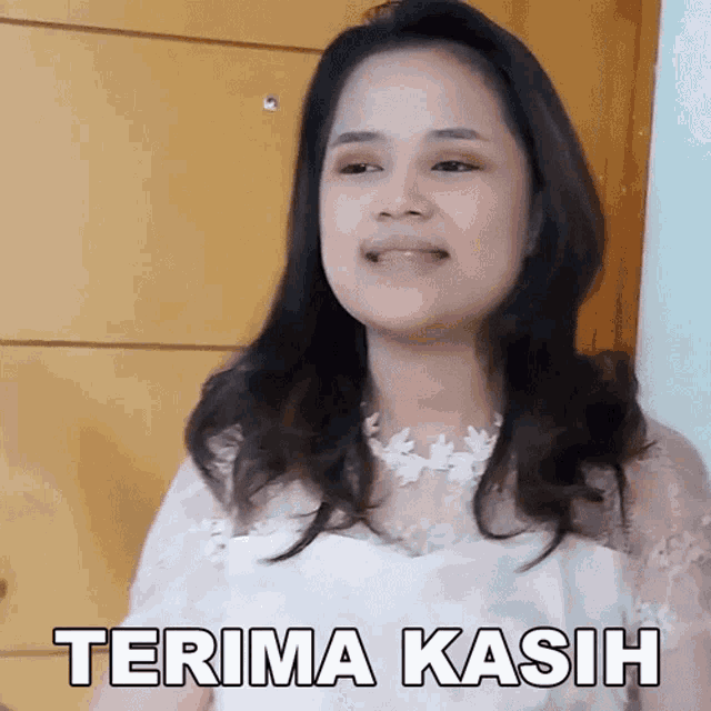a woman in a white dress says terima kasih on her face