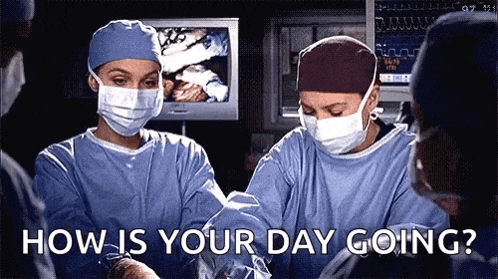 a group of surgeons wearing masks and scrubs are operating on a patient .