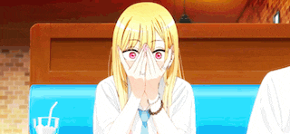 a girl covering her face with her hands in a restaurant