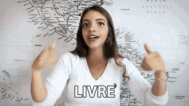 a woman giving a thumbs up in front of a map which says livre