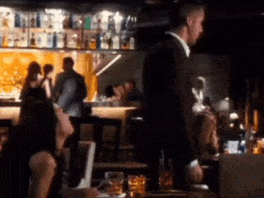 a man and a woman are sitting at a table in a restaurant