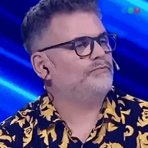 a man with glasses and a banana print shirt