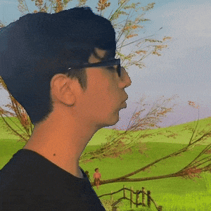 a man with glasses is standing in a field