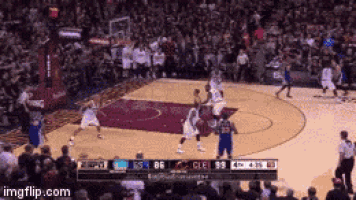 a basketball game is being played in front of a crowd and a scoreboard that says imgflip.com on it