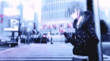 a blurry picture of a person standing in the middle of a city street .