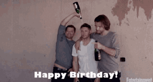 three men are celebrating their birthday with a bottle of champagne in their hand