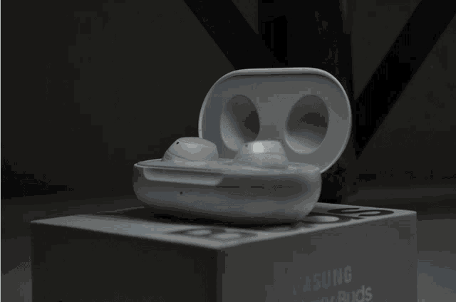 a pair of samsung galaxy buds sits on top of a box