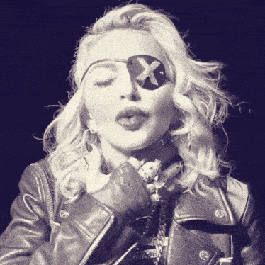a woman wearing a leather jacket has a patch on her eye that says x on it