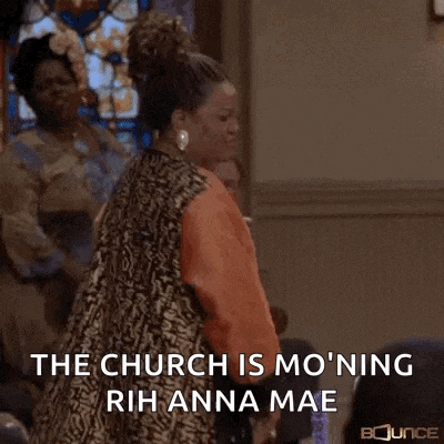 a woman is dancing in a church with a microphone in her hand .