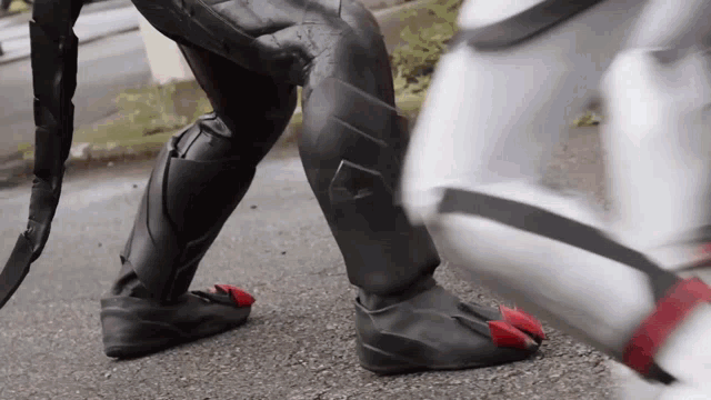 a person in a superhero costume is standing on a street .