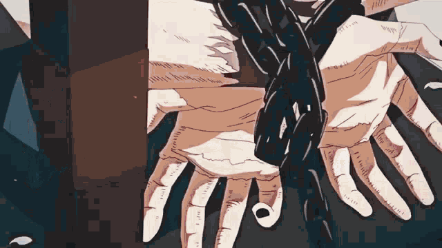 a close up of a person 's hands chained to a wall .