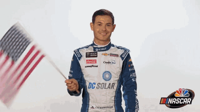 a man in a racing suit is waving an american flag and says happy 4th of july nascar