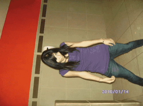 a woman in a purple shirt stands in a bathroom with the date 2010/01/14