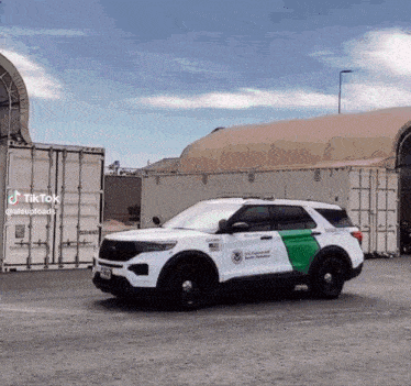 a u.s. customs and border protection vehicle is parked in front of a warehouse