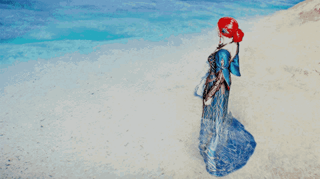 a woman in a blue dress stands on a beach