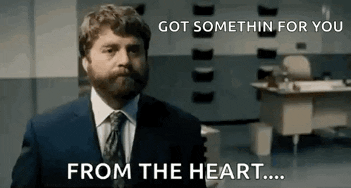 a man with a beard is wearing a suit and tie and says `` got somethin for you from the heart ... ''