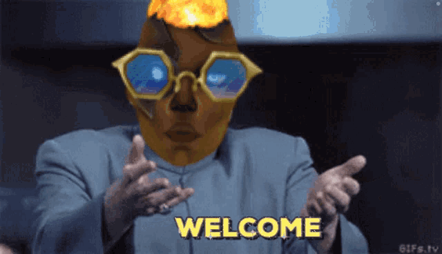 a man with glasses and a fire head says " welcome "