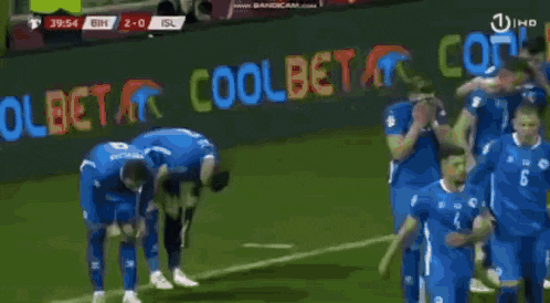 a man is walking on a soccer field during a match .