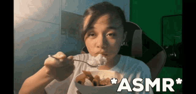 a woman is eating rice with a fork and the word asmr is on the bottom right