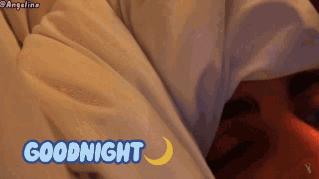 a person laying under a white blanket with the words goodnight written on it