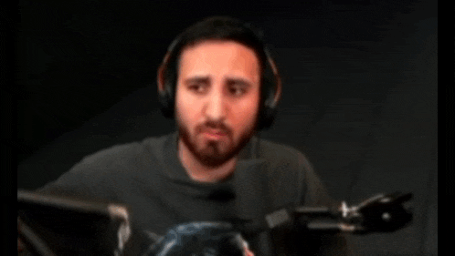 a man wearing headphones and holding a microphone