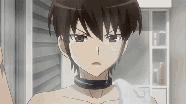 a boy with a choker around his neck is looking at himself in the mirror