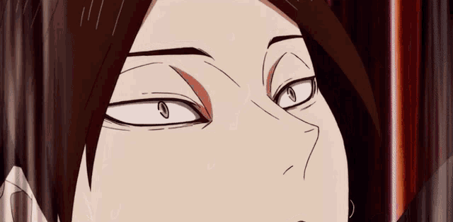 a close up of a person 's face with a slight smirk on their face