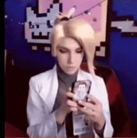 a woman in a white coat is holding a cell phone in her hand .