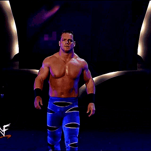 a shirtless wrestler is standing in front of a banner that says " chris benoit "