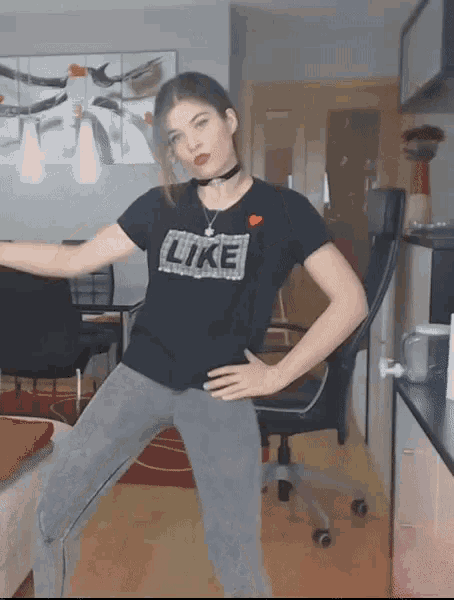 a woman is wearing a black shirt that says like on it