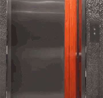 a person is standing in an elevator with chinese writing on the door