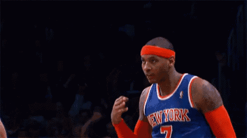 a basketball player for the new york knicks salutes during a game