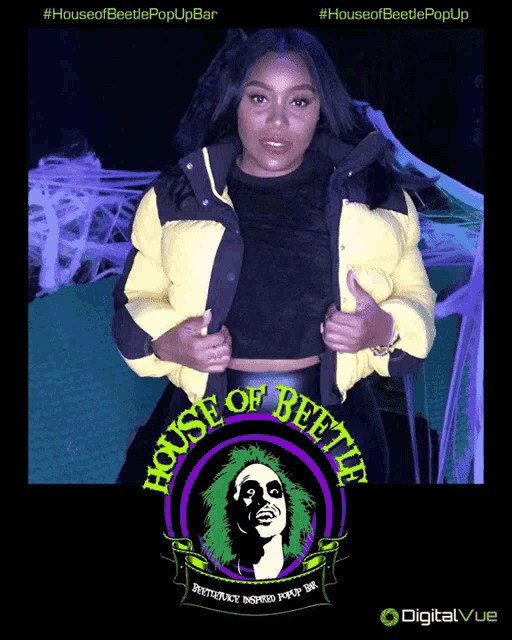 a woman is standing in front of a house of beetles logo