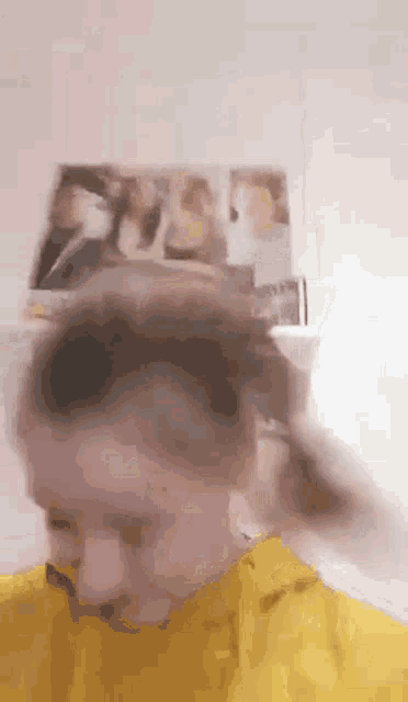 a blurry picture of a person wearing a yellow hoodie