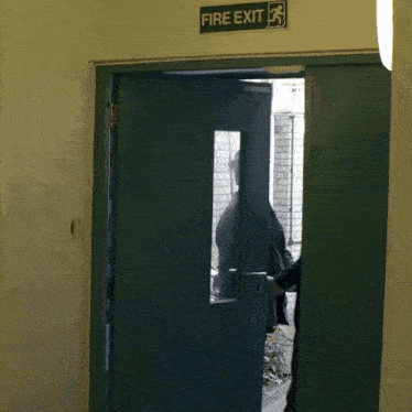 a fire exit sign hangs above a door