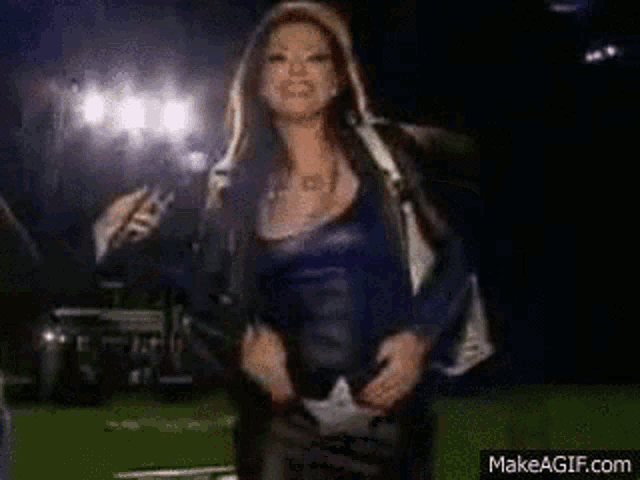 a woman with a very large breast is dancing with another woman .
