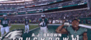 a blurred image of a football field with a player named a.j. brown in the foreground
