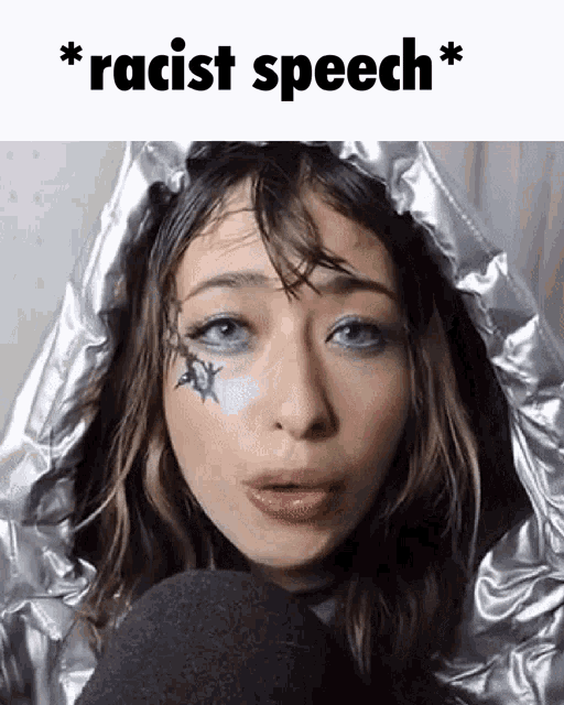 a woman with a tattoo on her face and the words racist speech