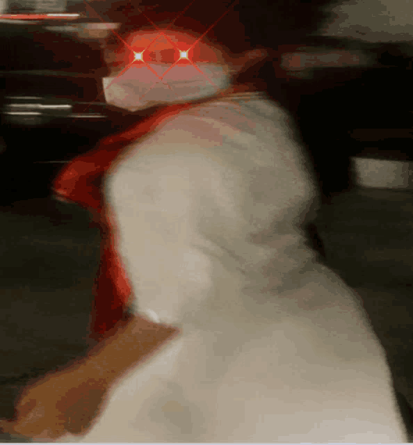 a blurry photo of a person wearing a mask with red eyes