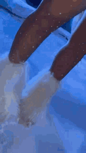 a close up of a person 's feet in a pool of water .