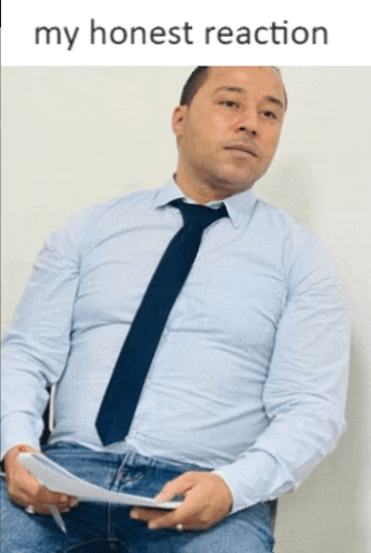 a man in a blue shirt and tie is holding a piece of paper with the words my honest reaction below him