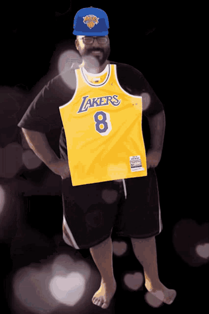 a man wearing a lakers jersey with the number 8