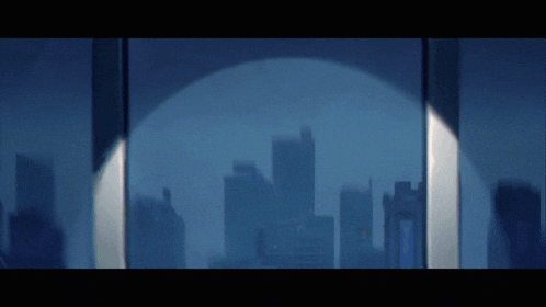 a city skyline is reflected in a glass window